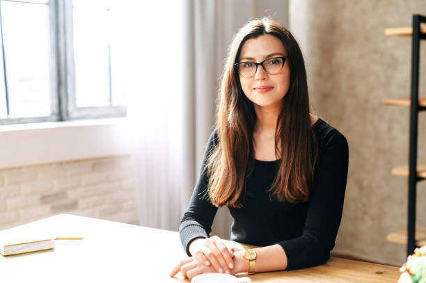 istock Young brunette successful woman sits at the table 1256477049