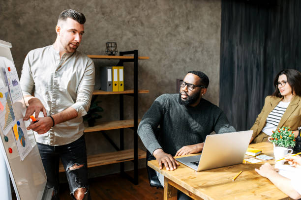 istock Presentation in a multiracial team in office 1256477068
