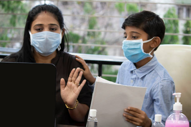 istock Boy bothering mother with schoolwork while she is working from home 1256477789