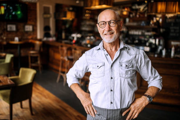 istock Senior cafe owner posing for a photo 1256479294