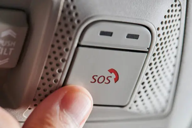 Pushing sos button in car during emergency close up view