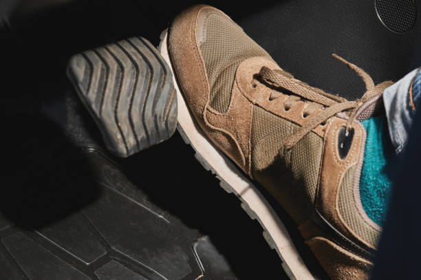 istock Man driving in sport shoes 1256481272