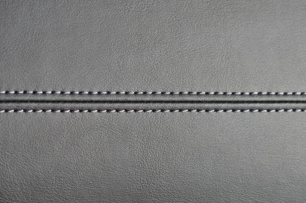 Stitches on black leather background Stitches on black leather background close up view leather care stock pictures, royalty-free photos & images