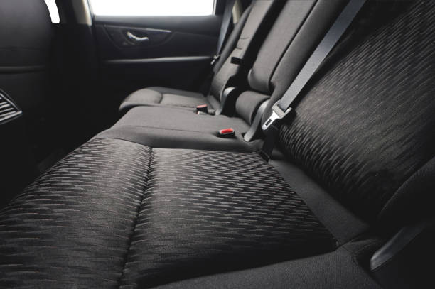 Close up of clean cloth car seat Close up of clean cloth car back seat with safety belts back seat photos stock pictures, royalty-free photos & images