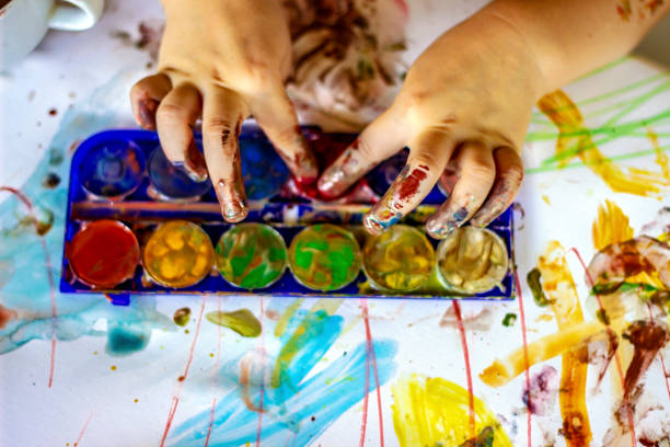 istock Small little hands making mess with watercolors. 1256482547