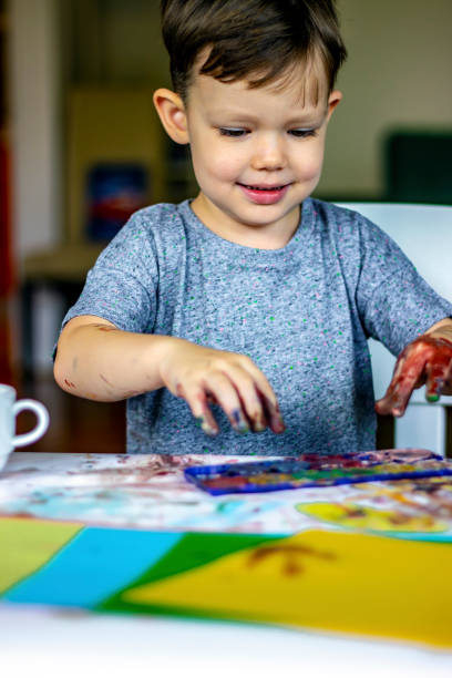 istock Happy beautiful child playing with colors. 1256482678
