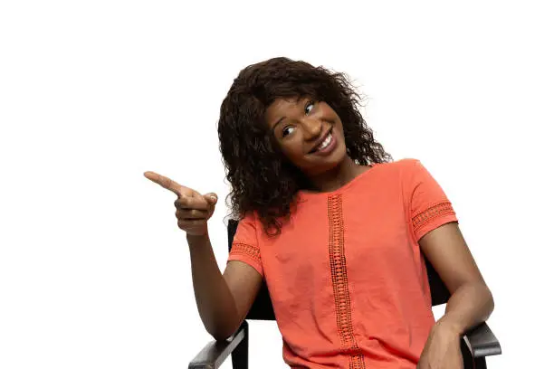 Photo of Young african-american woman with funny, unusual popular emotions and gestures isolated on white studio background