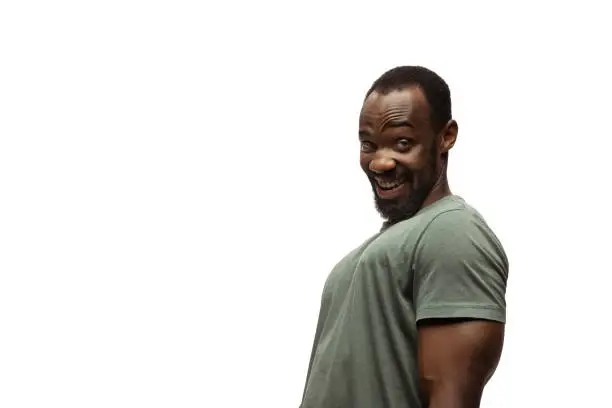 Photo of Young african-american man with funny, unusual popular emotions and gestures isolated on white studio background