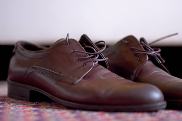 istock Brown shoes on the carpet 1256483929