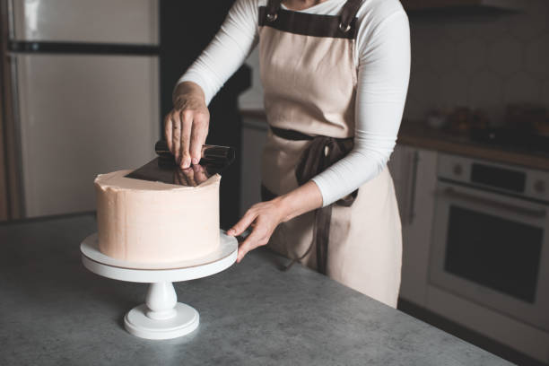 istock Woman making cake at home 1256484076