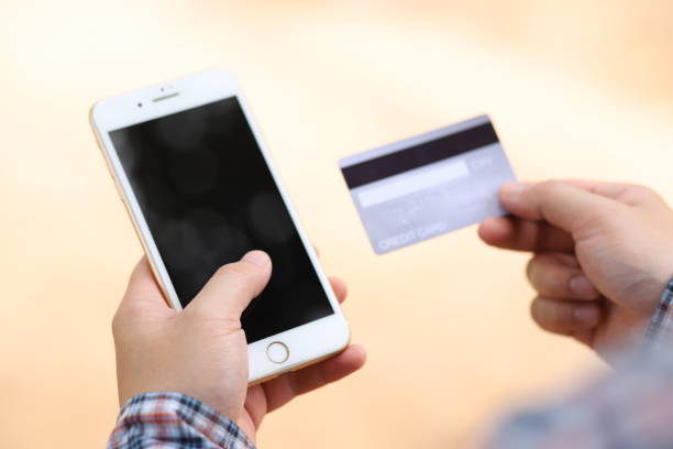 istock Credit card in hand With phone 1256486360