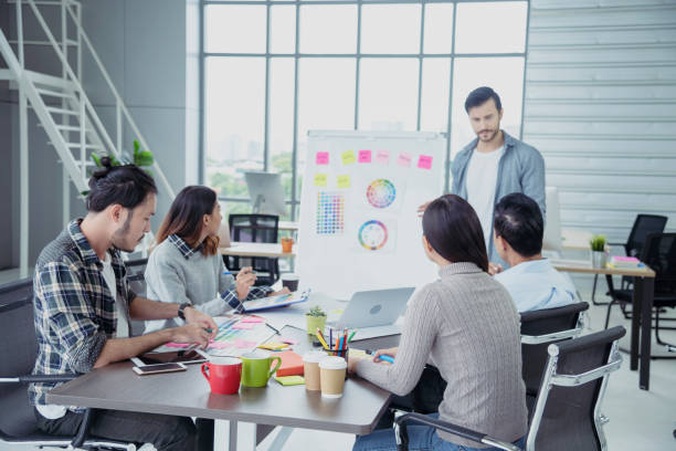 istock Diversity Creative Design Collaboration Team Meeting Communication with Business Partners Teamwork Working Together in Conference Room. Group of young people Meeting Trust in Businessman and Team. 1256486423