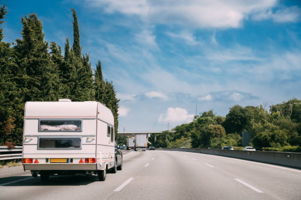 White Caravan Motorhome Car Goes On Highway Road White Caravan Motorhome Car Goes On Highway Road. RV truck stock pictures, royalty-free photos & images