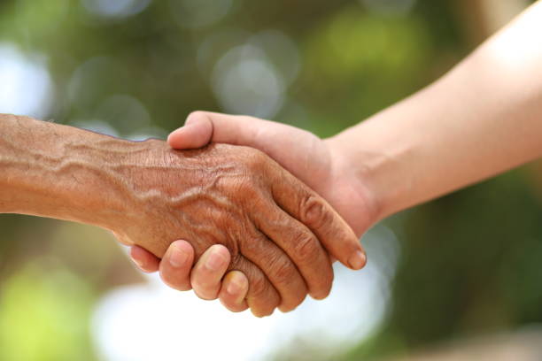 istock The image of holding a hand with an old man 1256486439