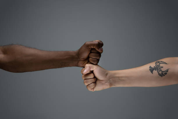 istock Racial tolerance. Respect social unity. African and caucasian hands gesturing isolated on gray studio background 1256488603