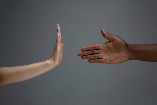 istock Racial tolerance. Respect social unity. African and caucasian hands gesturing isolated on gray studio background 1256488607