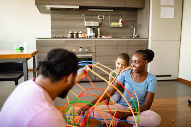 istock Mother, father and son having fun with creative toys 1256489637