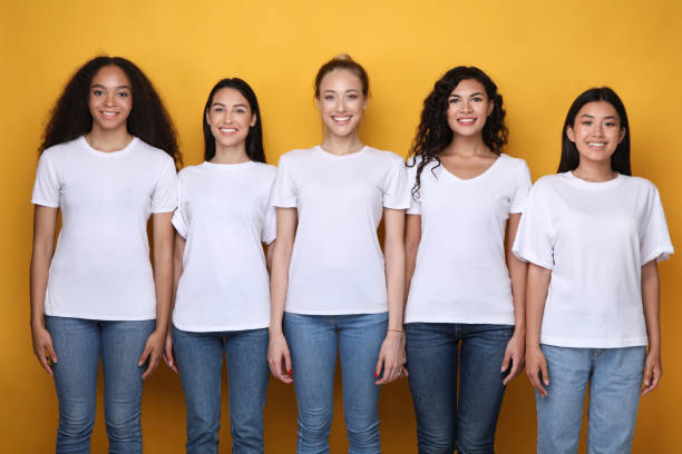 istock Five Diverse Girls Posing Standing Over Yellow Studio Background 1256490797