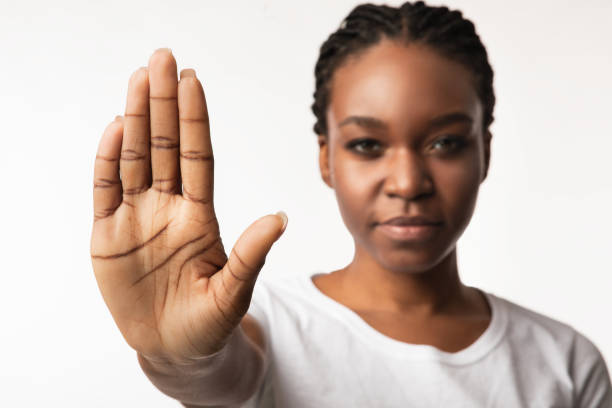 istock African American Girl Gesturing Stop Posing Over White Studio Background 1256491098