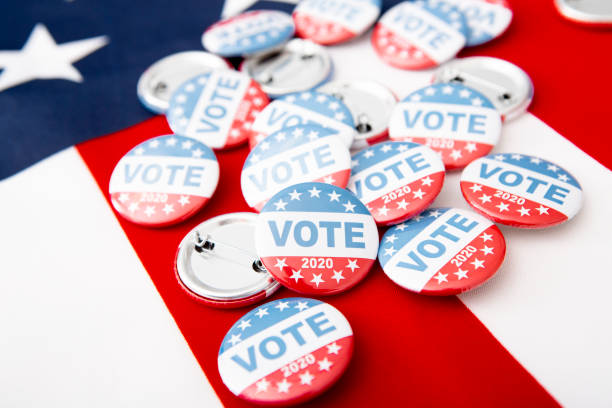 istock Patriotic pile of button pins on US flag background 1256493292