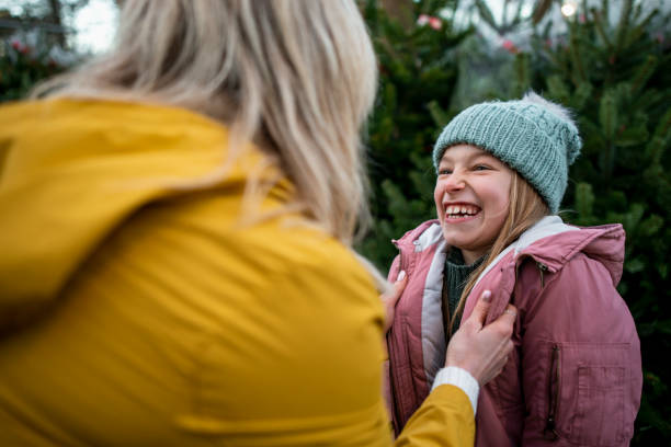 istock Mother Keeping Young Girl Warm 1256493537