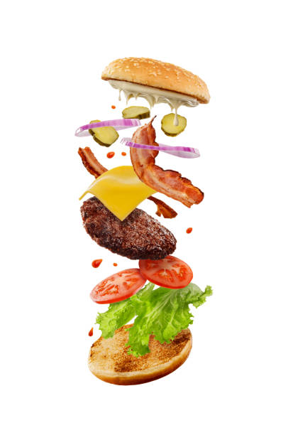 cheeseburger appétissant avec des ingrédients volants. industrie de la restauration rapide - symmetry burger hamburger cheese photos et images de collection