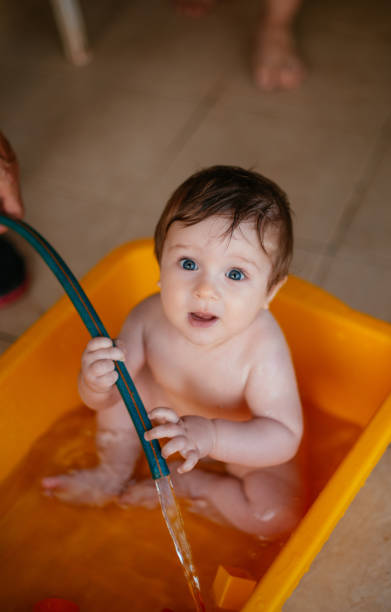 istock Cute Baby Playing in a Bathtub 1256494862