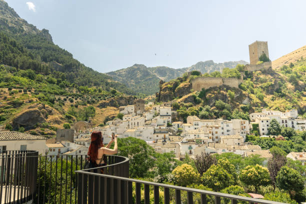 istock Girl form balcony taking picture while wearing mask on vacations 1256495142