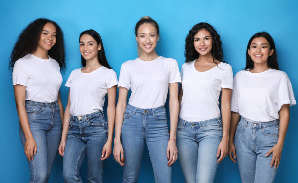 istock Five Model Girls Smiling To Camera Posing Over Blue Background 1256495486