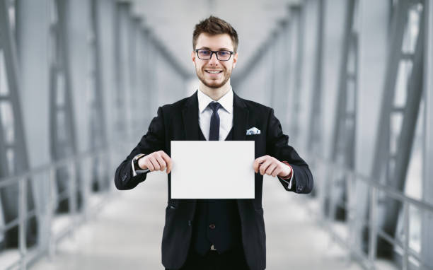 istock Man holding empty signboard at international airport 1256496784