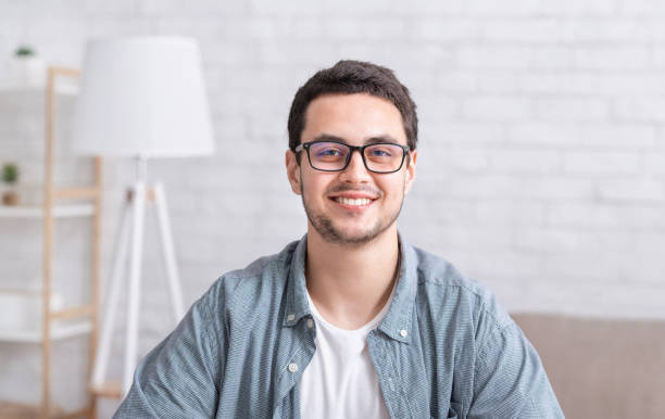 istock Young businessman working at home. Guy with glasses in interior 1256497232