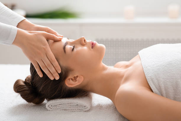 istock Young woman getting relaxing head massage at spa 1256497266