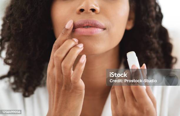Lip Care Unrecognizable Black Woman Applying Moisturising Chapstick On Lips Closeup Stock Photo - Download Image Now