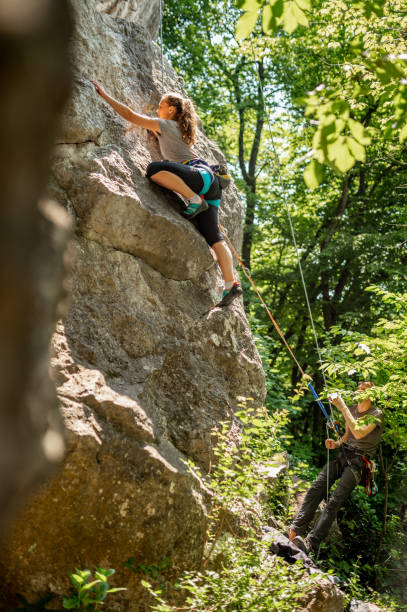 istock Female athlete climbing on the rock mountain 1256499121