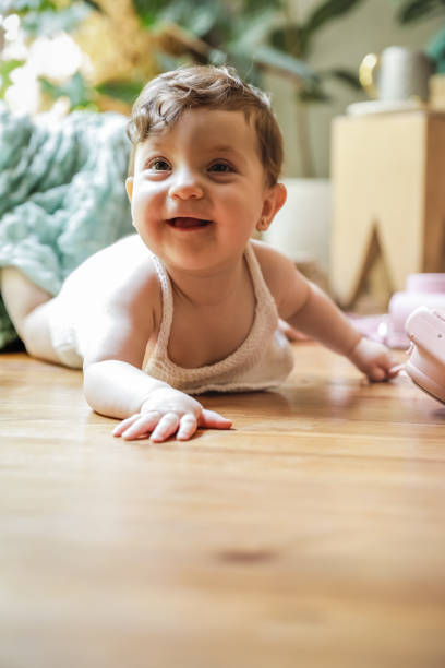 istock One year old baby playing on the floor with a vintage camera 1256501399