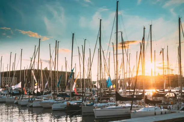 Photo of Stockholm, Sweden. Jetty With Many Moored Yachts During Summer Sailing Regatta In Sunset Lights
