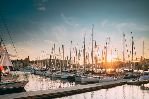 Stockholm, Sweden. Jetty With Many Moored Yachts During Summer Sailing Regatta In Sunset Lights.