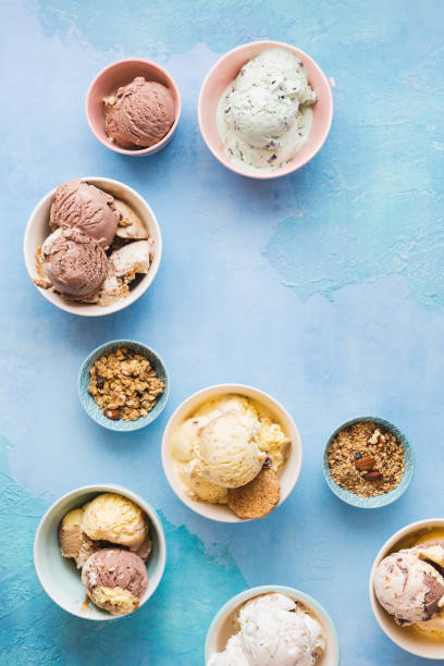 istock Different flavors of ice cream in small bowls on rustic blue background 1256503709