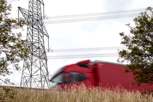 istock Lorry with motion blur viewed from low angle with pylon in background 1256504074