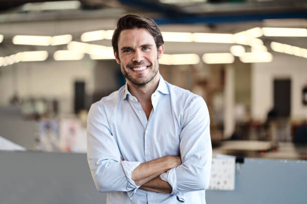 istock Smiling young designer standing in an open plan office 1256511576
