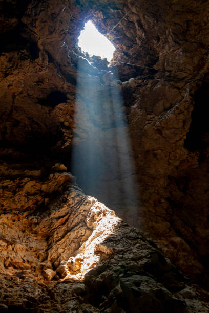 istock The sun light through on stone floor in nature cave at thailand 1256513045