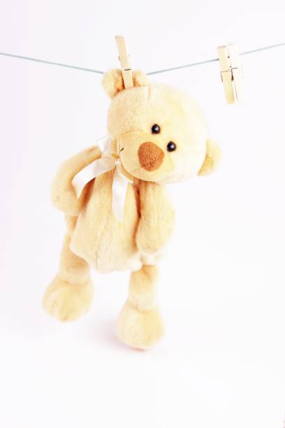 istock Animals backdrops. Beige Teddy bear hanging on a clothes line. 1256513971
