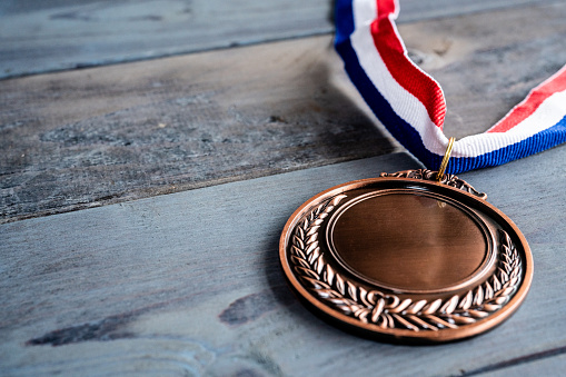 Bronze medal on wooden table