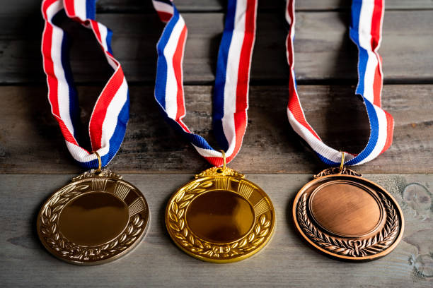 Gold and silver bronze medal on wooden table