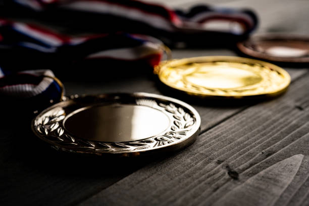 Gold and silver bronze medal on wooden table