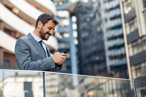 istock Attractive young businessman using a smart phone 1256518337