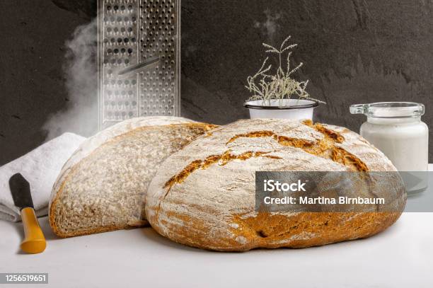 Freshly Baked Artisan Sourdough Bread With Sourdough Starter On A Kitchen Countertop Stock Photo - Download Image Now