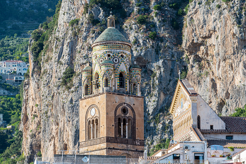 Close up view of the bell tower and the facade of the Amalfi Cathedral dedicated to the Apostle Saint Andrew at Amalfi city, Italy.