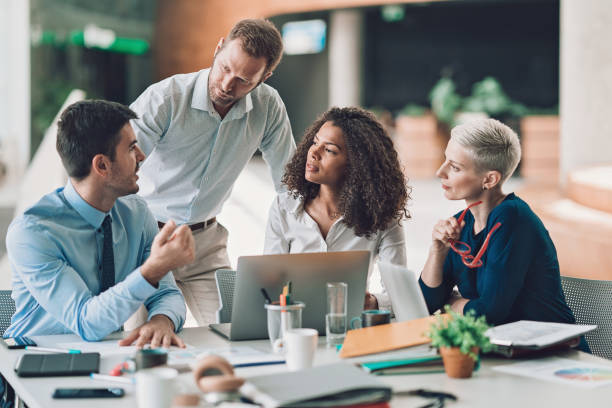 Group of entrepreneurs talking on a meeting Multi-ethnic group of entrepreneurs discussing business organised group stock pictures, royalty-free photos & images