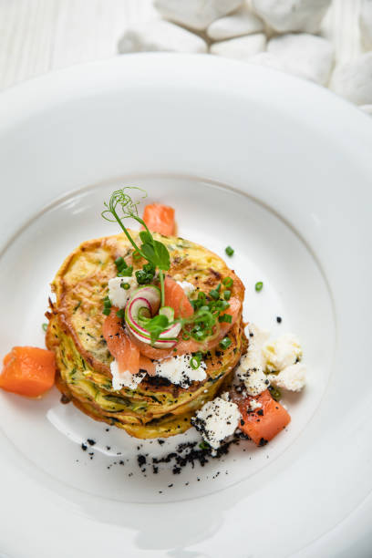 Pancakes with salmon, cheese, herbs